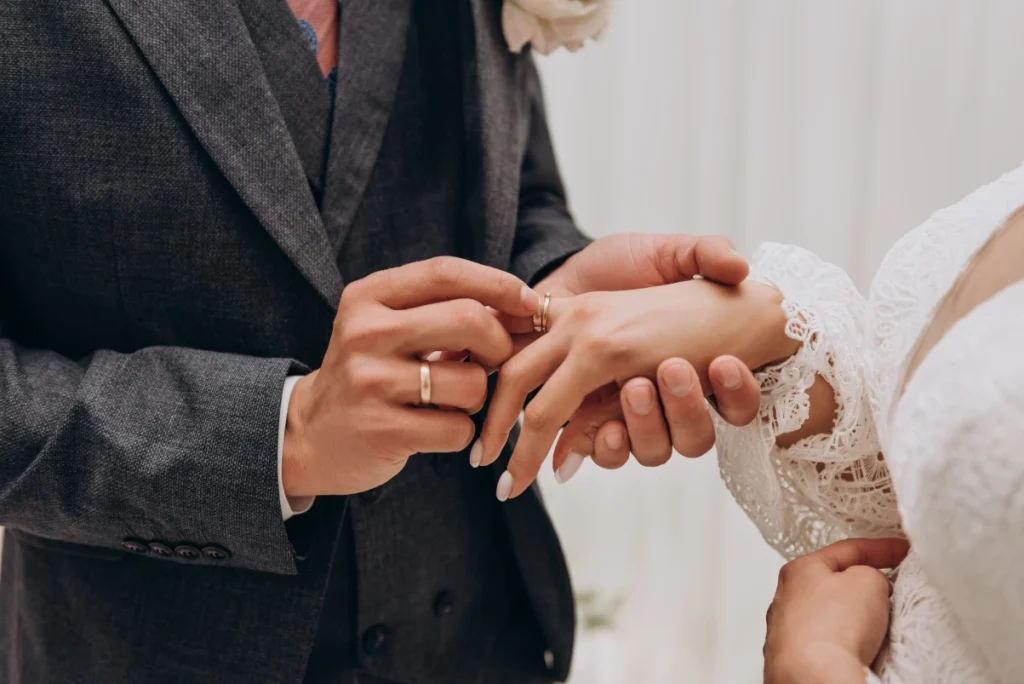 Close up of hand putting a wedding ring on her wife during the ceremonies